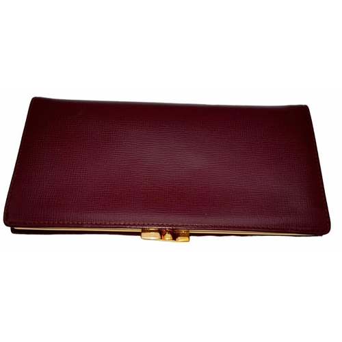 461 - Cartier Burgundy Leather Purse.
'CC' embossed logo on front with gold toned hardware. Back compartme... 