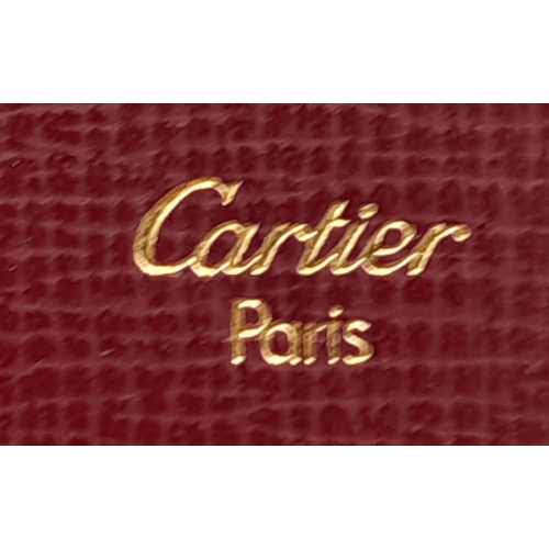 461 - Cartier Burgundy Leather Purse.
'CC' embossed logo on front with gold toned hardware. Back compartme... 