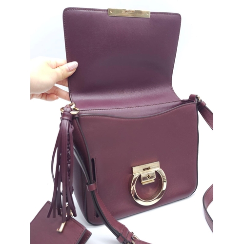 468 - Salvatore Ferragamo Leather Burgundy Shoulder Bag.
Comes with tasselled and woven vanity mirror with... 