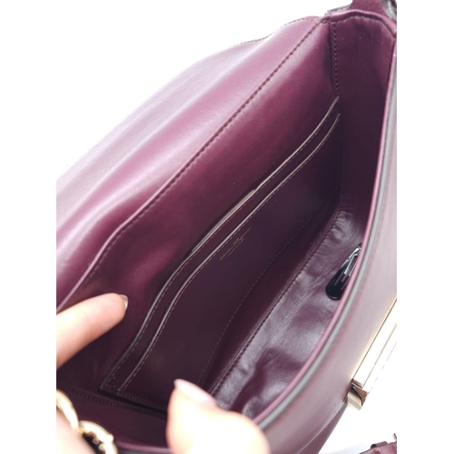 468 - Salvatore Ferragamo Leather Burgundy Shoulder Bag.
Comes with tasselled and woven vanity mirror with... 