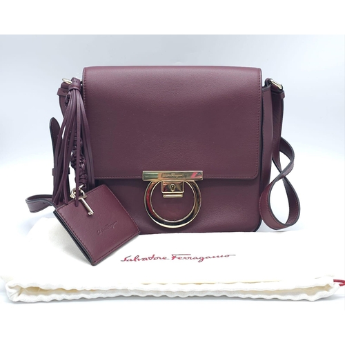 468 - Salvatore Ferragamo Leather Burgundy Shoulder Bag.
Comes with tasselled and woven vanity mirror with... 