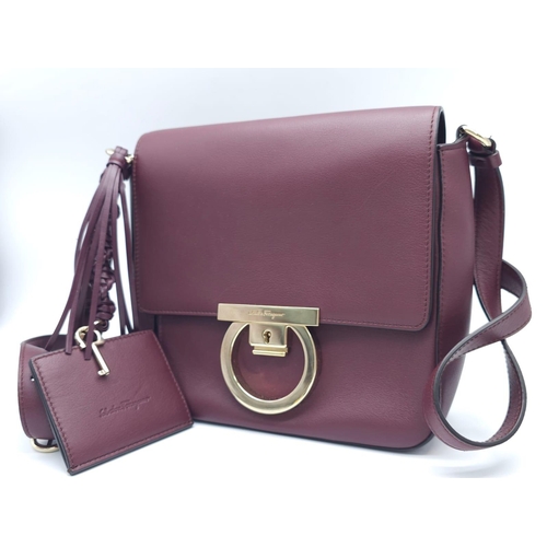 468 - Salvatore Ferragamo Leather Burgundy Shoulder Bag.
Comes with tasselled and woven vanity mirror with... 