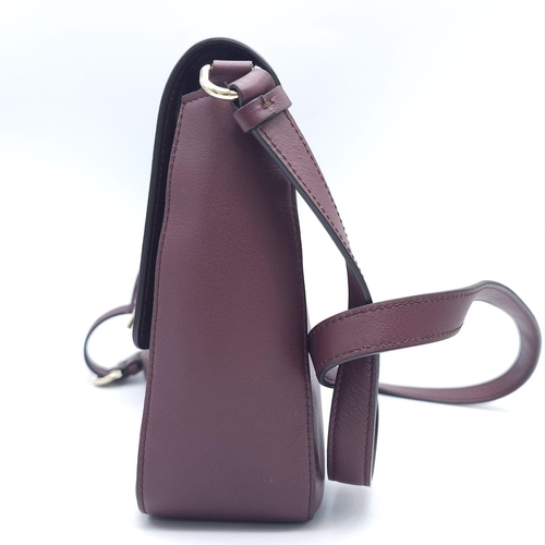 468 - Salvatore Ferragamo Leather Burgundy Shoulder Bag.
Comes with tasselled and woven vanity mirror with... 