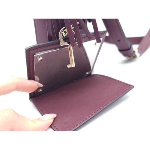 468 - Salvatore Ferragamo Leather Burgundy Shoulder Bag.
Comes with tasselled and woven vanity mirror with... 