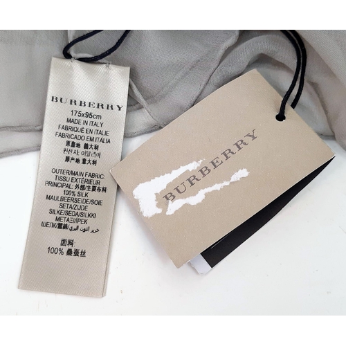 597 - Burberry Grey Animal Print Scarf.
Measures 175cm by 98cm and is 100% silk. Made in Italy. Comes in b... 