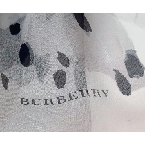 597 - Burberry Grey Animal Print Scarf.
Measures 175cm by 98cm and is 100% silk. Made in Italy. Comes in b... 