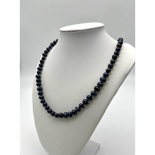 625 - A Black Akoya Cultured Freshwater Pearl Necklace. 5/6mm pearls. 68cm length.