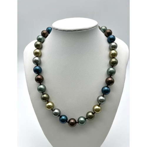 654 - A Seductive Four Colour South Sea Bead Necklace. Grey, blue, gold and silver 12mm shell beads. Heart... 