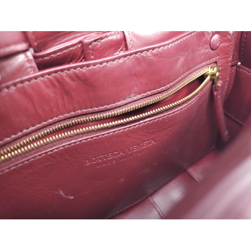 73 - Bottega Veneta Brick Cassette Bag.
Smooth burgundy leather, signature orthogonal weaving, adjustable... 