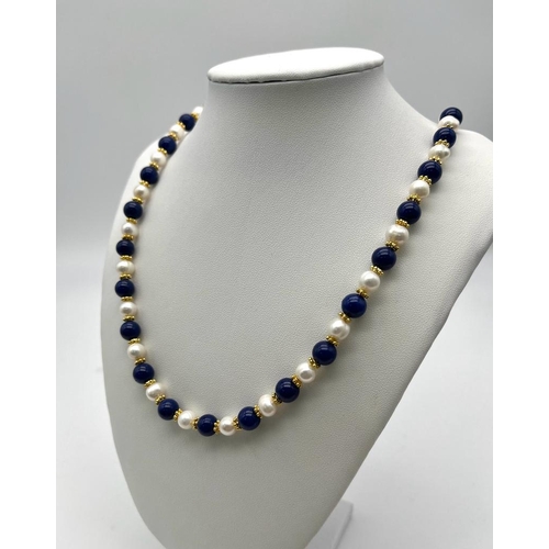 732 - A Lapis Lazuli and Cultured Pearl Necklace. 7/8mm lapis and pearls. Gilded spacers and clasp. 60cm n... 