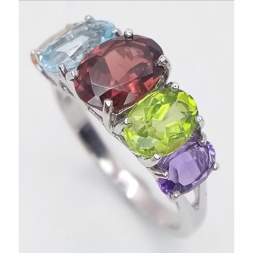 777 - An Unworn Sterling Silver Multi Gemstone Ring.
Size O. Set with Oval Cut Garnet, Topaz, Peridot, Cit... 