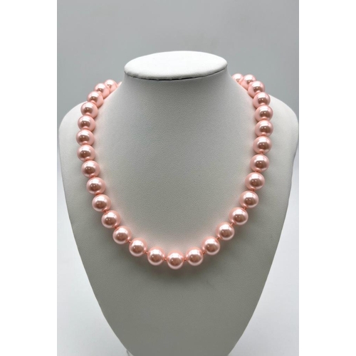 825 - A Charming Pink South Sea Pearl Shell Bead Necklace. 12mm shell beads. 44cm necklace length. Heart c... 