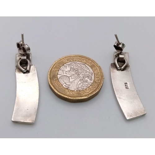 1076 - A PAIR OF DESIGNER SILVER EARRINGS .   10.2gms