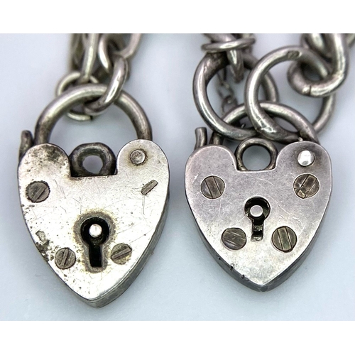 1473 - 2X vintage sterling silver charm bracelet with heart padlocks. Total weight 14G. Total length 18cm.