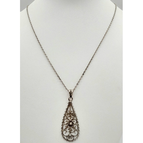 1476 - AN INTERCUT SILVER PENDANT ON A 44cms SILVER CHAIN.   5.5gms