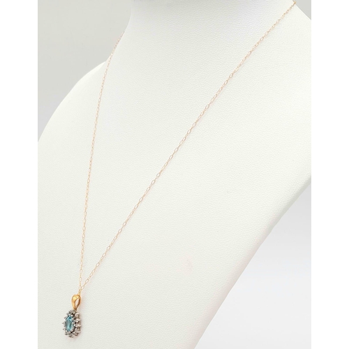 1511 - A VERY PRETTY AQUAMARINE PENDANT SET IN 9K GOLD ON A 42cms 9K GOLD CHAIN .  1.5gms