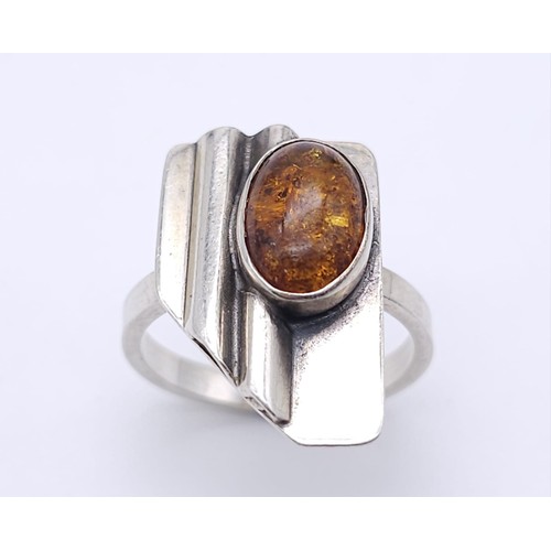 1200 - A Vintage Sterling Silver Modernist Design Amber Set Ring.
Size K. Crown Measures 1.9cm and is set w... 