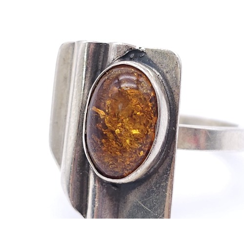 1200 - A Vintage Sterling Silver Modernist Design Amber Set Ring.
Size K. Crown Measures 1.9cm and is set w... 