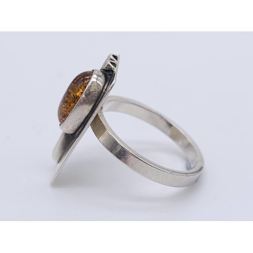 1200 - A Vintage Sterling Silver Modernist Design Amber Set Ring.
Size K. Crown Measures 1.9cm and is set w... 