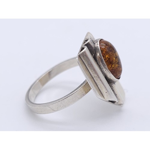 1200 - A Vintage Sterling Silver Modernist Design Amber Set Ring.
Size K. Crown Measures 1.9cm and is set w... 