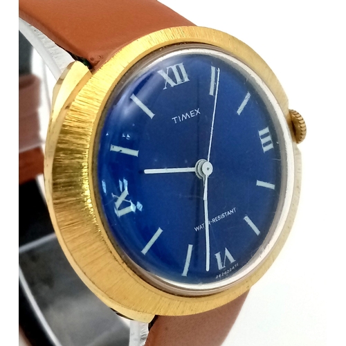 1441 - A Vintage Timex Blue Face Mechanical Watch. Brown leather strap. Gold plated oval case - 39mm. Mecha... 