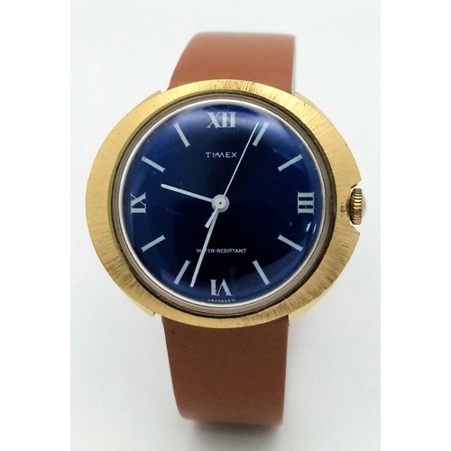 1441 - A Vintage Timex Blue Face Mechanical Watch. Brown leather strap. Gold plated oval case - 39mm. Mecha... 