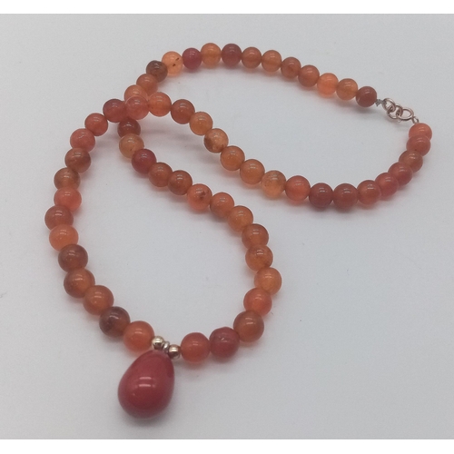 1462 - Beaded Orange Stone Necklace, Red Stone Pendant.
38cm in length.