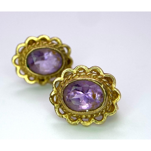 1413 - A Pair of Vintage 9K Yellow Gold Amethyst Earrings. Oval amethysts in a decorative setting. 2.4g tot... 