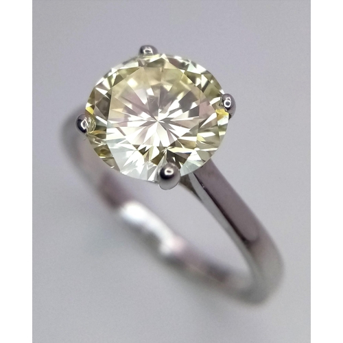 1553 - An 18K White Gold and 2.47ct VVS Yellow Diamond Ring. A brilliant round cut dancing centrepiece - No... 