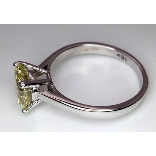 1553 - An 18K White Gold and 2.47ct VVS Yellow Diamond Ring. A brilliant round cut dancing centrepiece - No... 