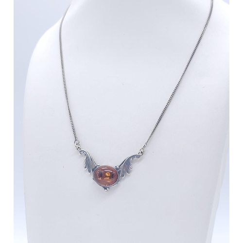 1504 - A 925 Silver Necklace with Amber Lavaliere. Amber cabochon central to two decorative wings. 42cm. 6.... 