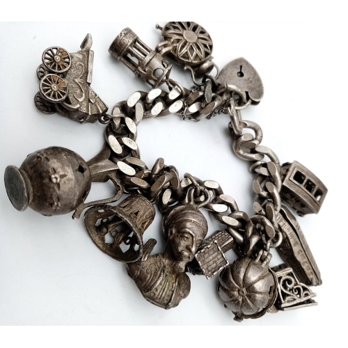 1518 - A very unique vintage silver bracelet with multiple charms such as Egyptian Pharaoh, classic auto mo... 