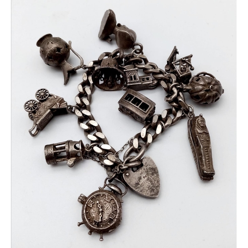 1518 - A very unique vintage silver bracelet with multiple charms such as Egyptian Pharaoh, classic auto mo... 