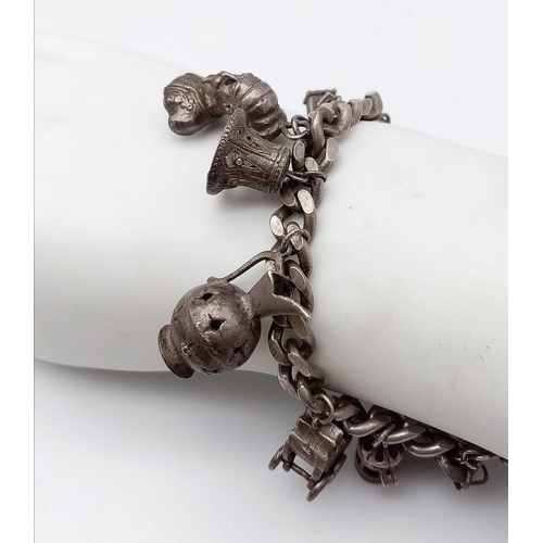 1518 - A very unique vintage silver bracelet with multiple charms such as Egyptian Pharaoh, classic auto mo... 