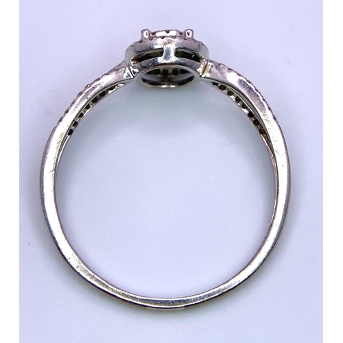 1415 - A 9K White Gold Diamond Double Halo Ring. Central diamond with double diamond halo and shoulder acce... 