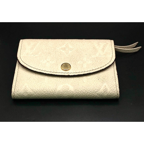 1604 - A Louis Vuitton Beige Leather Purse/Wallet. Decorative monogram exterior. Zipped inner compartment. ... 