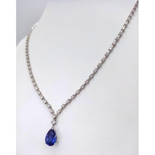 1681 - An 18kt White Gold, Diamond Necklace featuring a stunning Blue Sapphire. The 40cm necklace begins wi... 