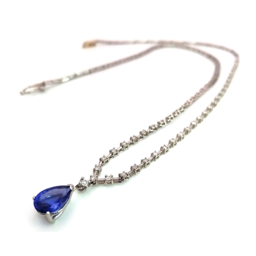 1681 - An 18kt White Gold, Diamond Necklace featuring a stunning Blue Sapphire. The 40cm necklace begins wi... 