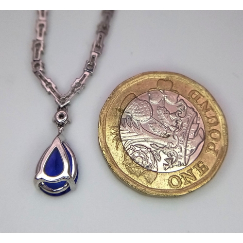 1681 - An 18kt White Gold, Diamond Necklace featuring a stunning Blue Sapphire. The 40cm necklace begins wi... 