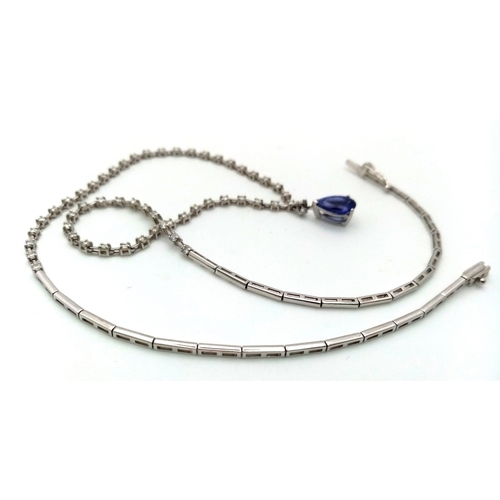 1681 - An 18kt White Gold, Diamond Necklace featuring a stunning Blue Sapphire. The 40cm necklace begins wi... 