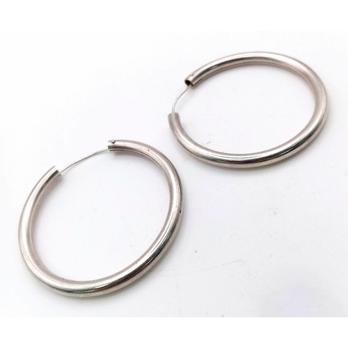 1997 - A large pair of sterling silver hoop earrings, diameter: 43 mm, weight: 11.8 g.