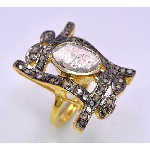 105 - A spectacular antique silver and gold ring with a large natural, uncut diamond (3 carats appr.) surr... 