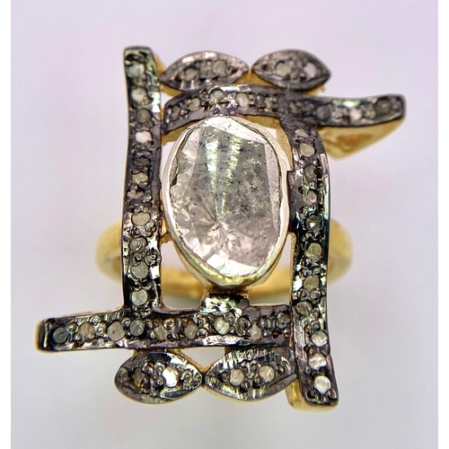 105 - A spectacular antique silver and gold ring with a large natural, uncut diamond (3 carats appr.) surr... 