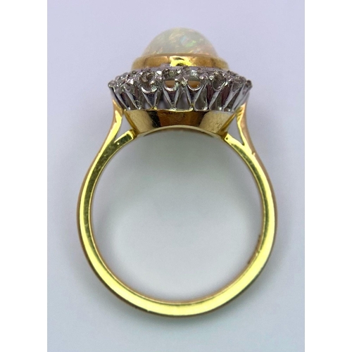 107 - A Vintage 18K Yellow and White Gold, Opal Ring. Central opal cabochon with excellent colour-play. Si... 