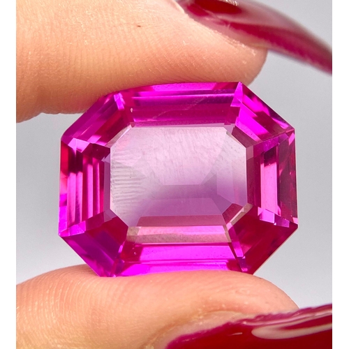 112 - An amazing, large (41,1 carats), emerald cut, pink RUBY with very interesting optical properties due... 