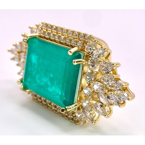 140 - A highly glamorous PRINCES JEWELLERY DESIGN cocktail ring, with a massive emerald (lab created)
surr... 