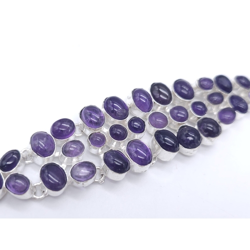 168 - A sophisticated bracelet with large amethyst cabochons. Length: 17-22 cm, weight: 56.6 g. In a prese... 