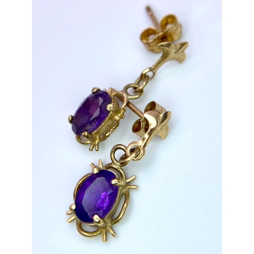 1740 - A Pair of Vintage 9K Yellow Gold Small Fleur de Lis Amethyst Gemstone Drop Earrings. 15mm drop. 0.95... 