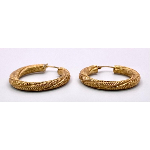 703 - A Pair of Rich and Twisted 9K Yellow Gold Hoop Earrings. 2.85g total weight.