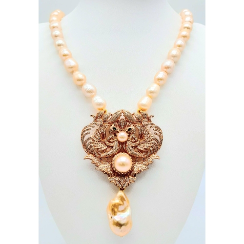 175 - A fabulous natural pearl necklace with a statement pendant loaded with cubic zirconia and a large ba... 